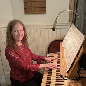 Catherine (Cathy) Cargill Koch sitting at an organ console.